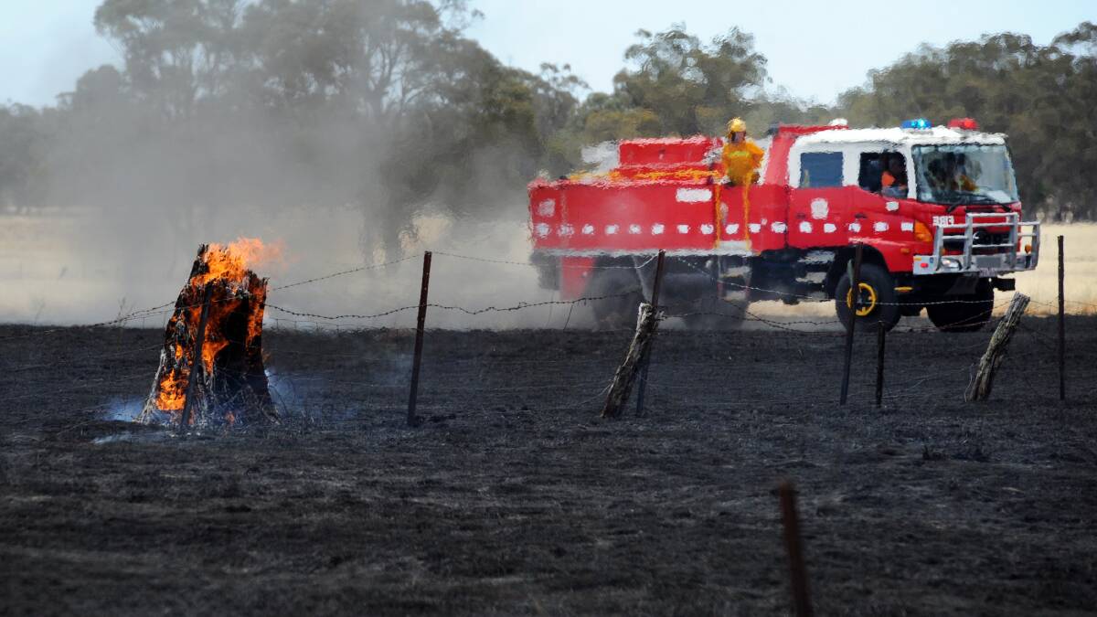 TAKING ACTION: Fire crews douse a grass fire at Lower Norton in November 2014. Horsham Fire Brigade Captain John St Clair has called on people to prepare for the fire season now. 