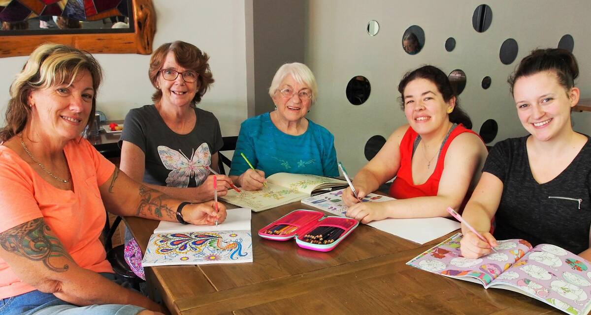CREATIVE: On the third Saturday of each month a group of women gather up their colouring books and pencils and head to Horsham's UpTempo cafe. The popular activity attracts women and girls of all ages with organiser Shirley McMartin convinced the participants enjoy opportunity to chat as much as they enjoy the colouring in. She said all were welcome to join in. Serious colouring starts at 1pm. Pictured from left are Kerryn Richards, Shirley McMartin, Joan Green, Peta Markby and Tamara Smith. Picture: CONTRIBUTED