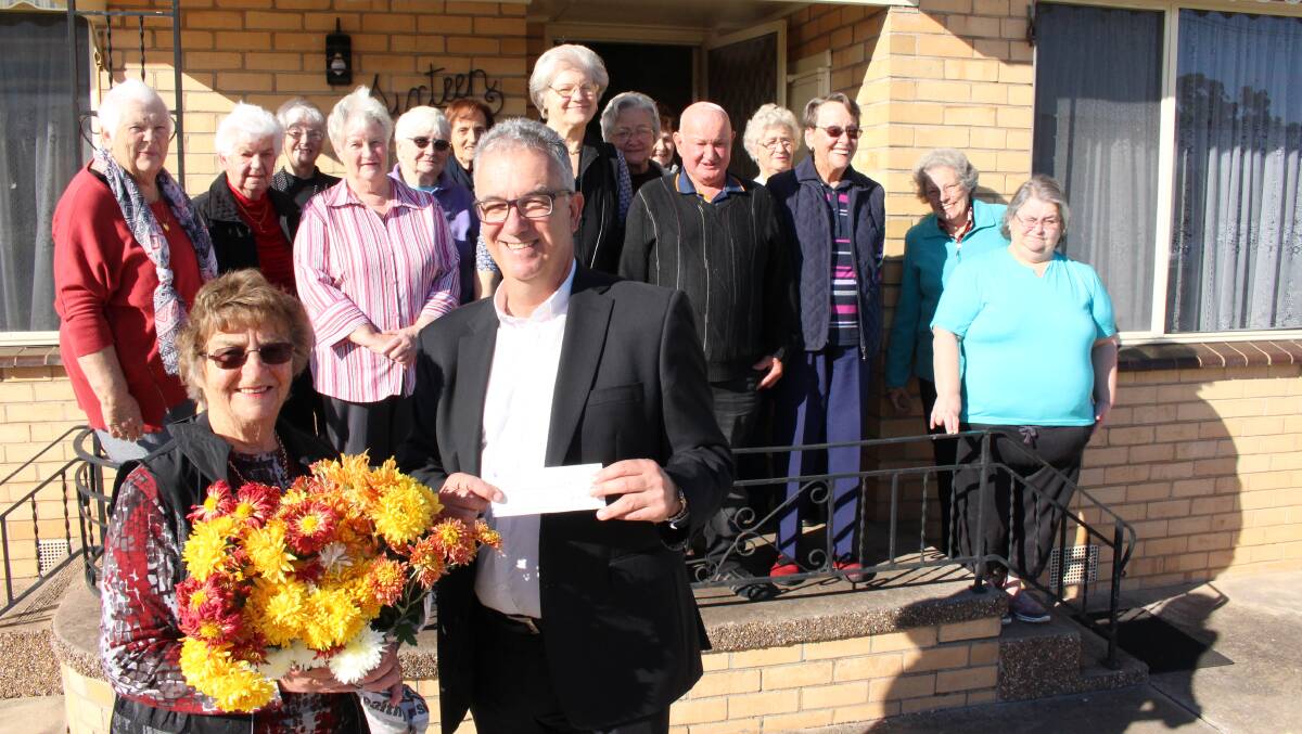 BLOOMIN' MARVELLOUS: Fundraising organiser Enid King and Wimmera Health Care Group acting chief executive Mark Knights with members involved in the fundraising efforts.