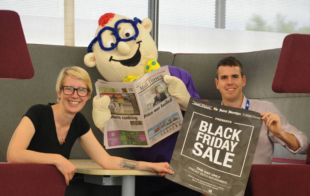 LET'S GO: Sales team members Eve Johnson and Hayden Kemp with mascot Super Scoop, centre, prepare for the Black Friday sales promotion on Friday. 