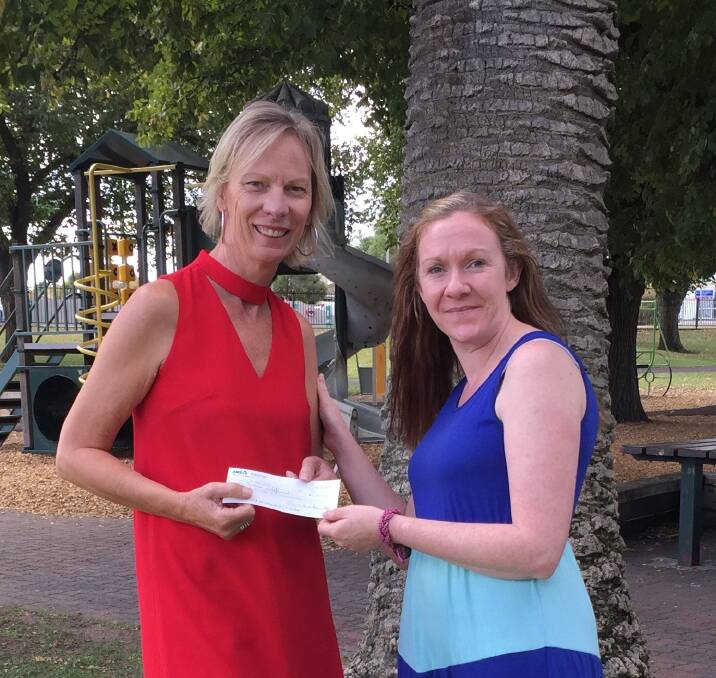Business Horsham’s Wendy Mitchell hands over the final contribution and the program to Uniting Wimmera’s Meredith Knoop in May Park - where the campaign had its origins. Picture: CONTRIBUTED