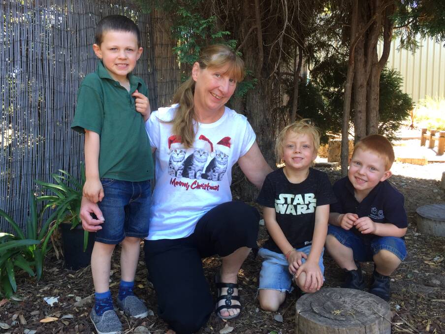 FAREWELL: Julie McClure pictured with Oliver, Eden and Brandon says goodbye to Cooinda and Marrang Kindergartens after 18 years of service. Picture: Anthony Piovesan