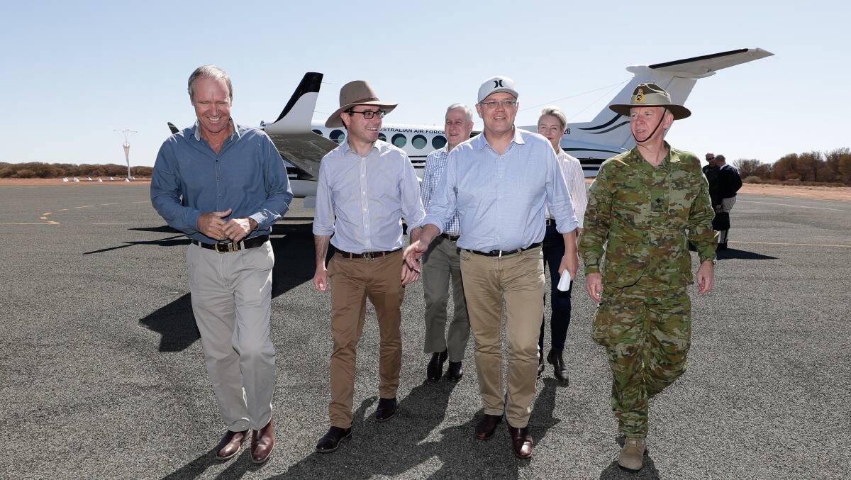 CHARTER: Riverina MP Michael McCormack (centre rear) and Prime Minister Scott Morrison arrive by RAAF private plane at Quilpie for a tour of drought-affected areas of Queensland in August last year. Picture: Alex Ellinghausen