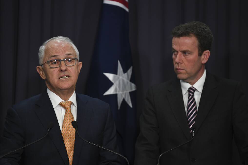 Prime Minister Malcolm Turnbull speaks as Minister for Social Services Dan Tehan looks on during a press conference to outline the government's formal response to the Royal Commission into Institutional Responses to Child Sexual Abuse. Picture: AAP/Lukas Coch