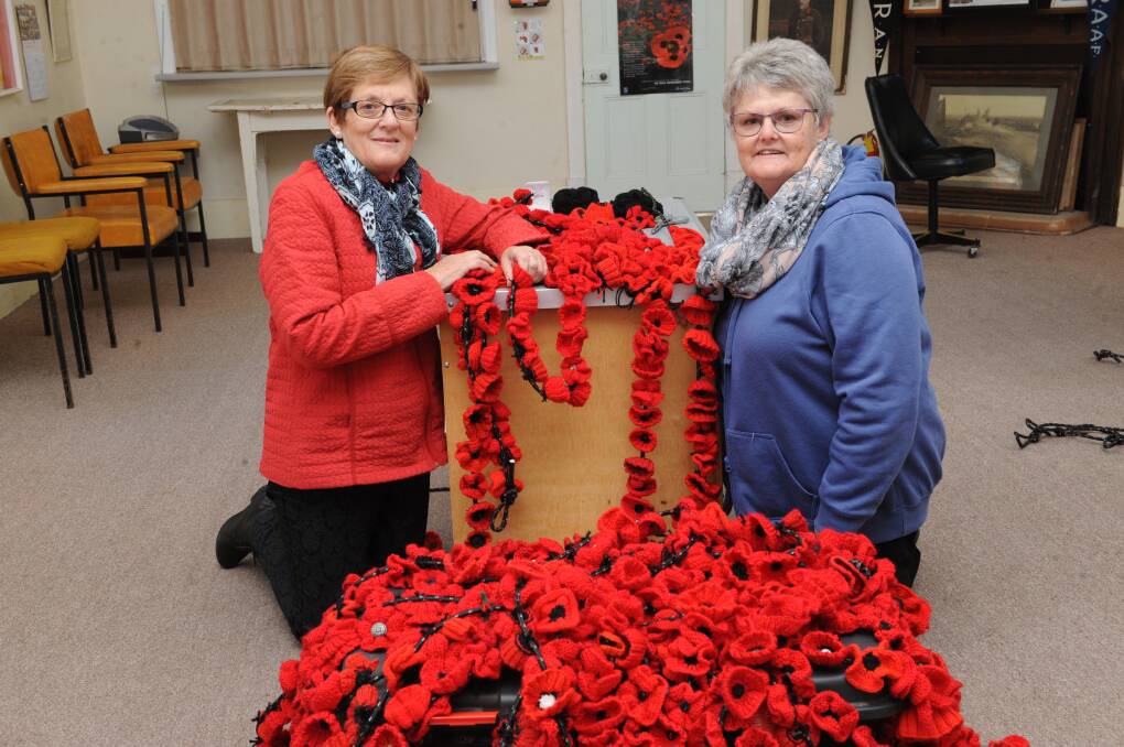Nhill RSL members Pam Deckert and Rosie Clark with the crocheted poppies in 2019. Picture: SONIA SINGHA