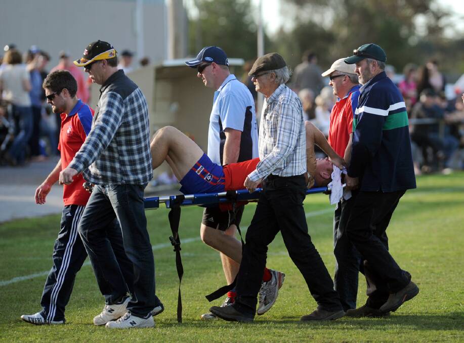 Josh Beddison carried off on a stretcher after a concussion in the 2013 second semi-final between Kalkee and Laharum.