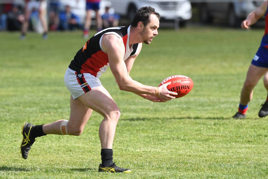 Milner handballs with Edenhope-Apsley in 2018. Milner played nine games with the Saints in 2019. Picture: SAMANTHA CAMARRI