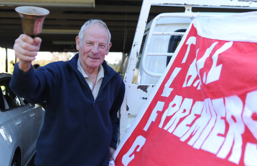  Rob Kelm with the old timekeepers bell and Taylors Lake's 1952 premiership flag. Picture: RICHARD CRABTREE