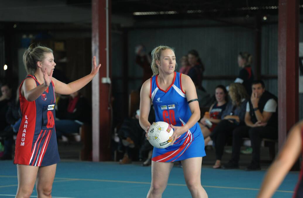 Rupanyup's Kayla Woods with the ball in hand inside Rupanyup's indoor netball court.
