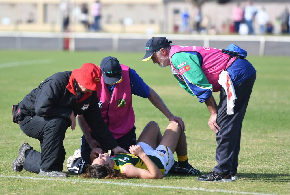 Kalkee's Jasper Gunn is assessed for concussion during last year's interleague contest. After a blistering start to the game, Gunn did not return to the field. Picture: RICHARD CRABTREE