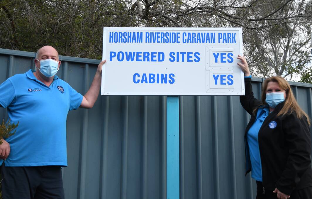 STOKED: Glenn Coffey and Sue Jones were ecstatic to put 'YES' back on the vacancy sign. Picture: RICHARD CRABTREE