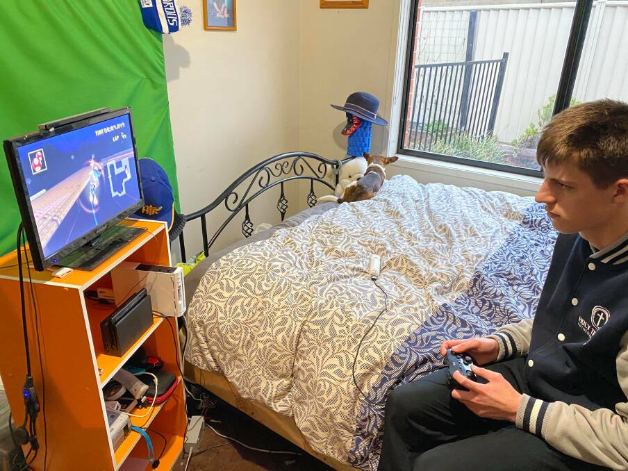 PRACTICE: Cooper Walter playing Mario Kart on Wii. Pictures: CONTRIBUTED 