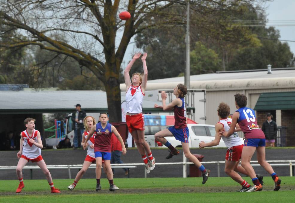 Ruckman fly during the Wimmera Football League's under-14 grand final. 
