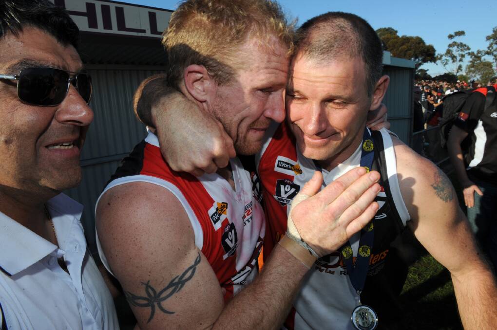 Phil Butsch and Gavin Kelm celebrate Horsham Saints' first WFL premierships. Kelm played in the reserves.