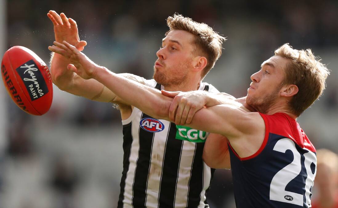 Oscar McDonald of the Demons and Jordan Roughead of the Magpies compete for the ball. Picture: MICHAEL WILSON/AFL PHOTOS