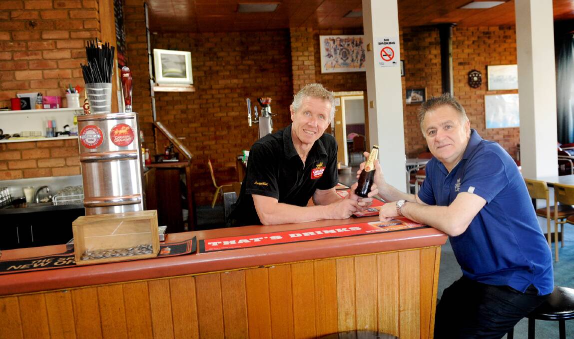 Bruce Hartigan (left) at the bar of the White Hart Hotel on Firebrace Street, Horsham.