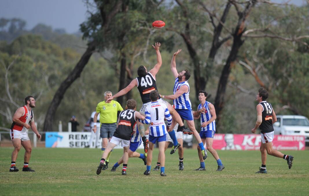 Saints' Jak Ryan contests against Anthony Close. It was Close's first senior game of the season in 2019 after coming back through the reserves in round three.
