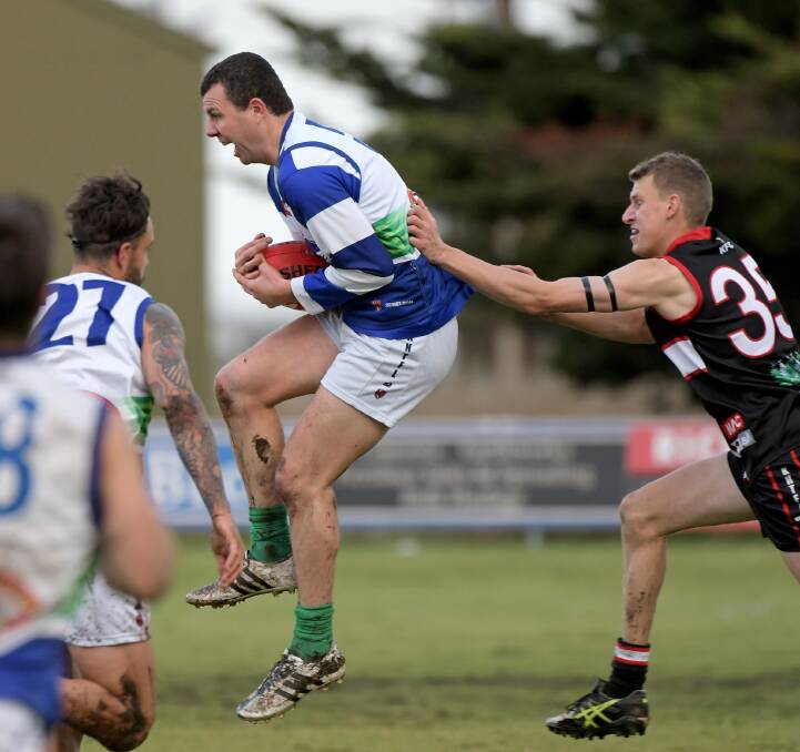 Kaniva-Leeor's playing-coach Nick Murphy marks in front of Kingston opponent William Goode. Picture: NARACOORTE HERALD