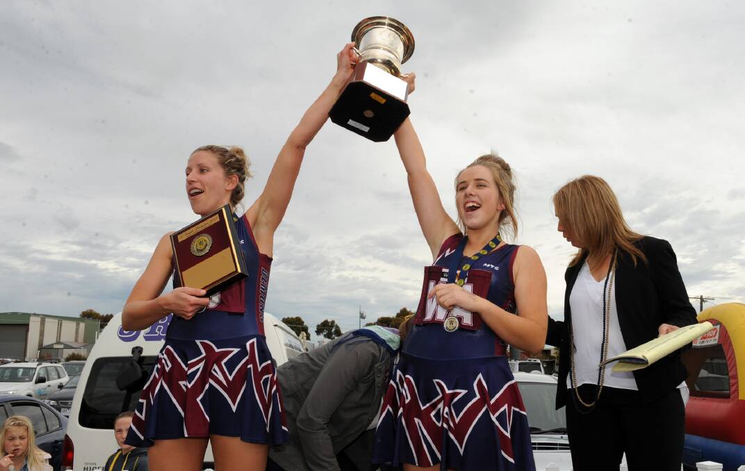 Lloyd hoists the trophy with Emma Uebergang in 2013.