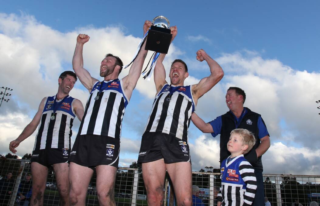 Minyip-Murtoa coach John Delahunty, co-captains Angus Trethowan and Luke Chamberlain, and president Scott Arnold with the 2019 premiership cup. Picture: PETER PICKERING