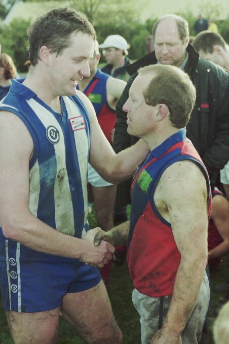 The coaches shake hands after the match. Jamie Templeton and Scott Batchelor.