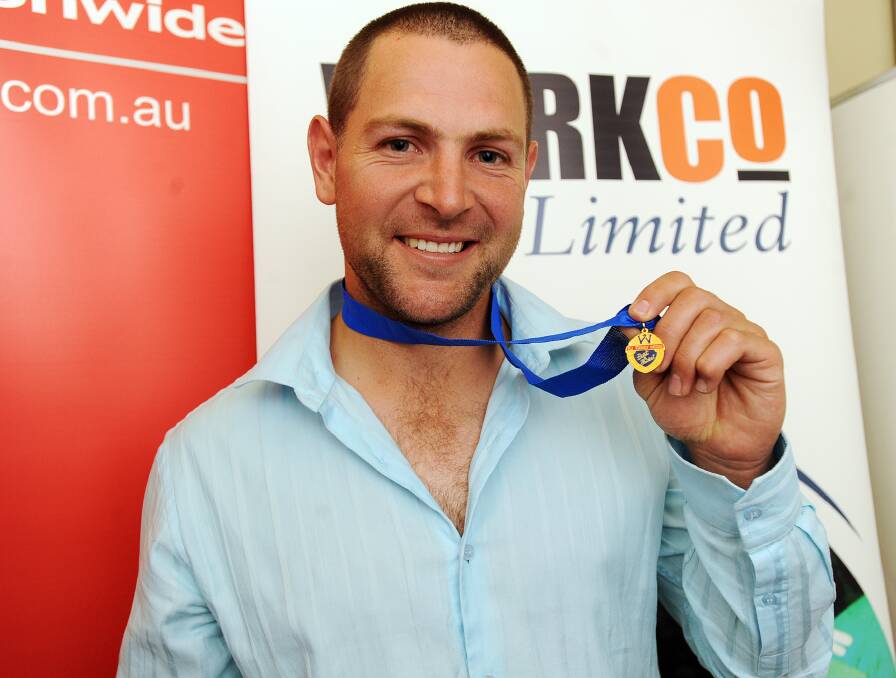 Schultz with the 2011 Toohey Medal.