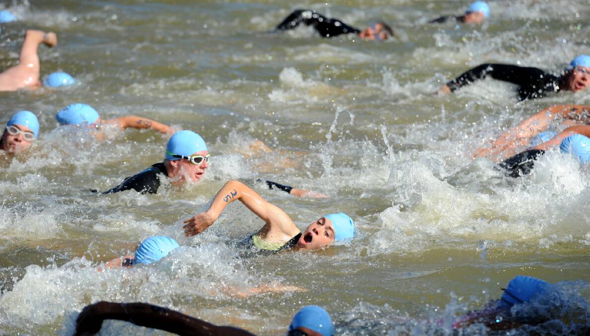 Competitors in action during the swimming leg of the Horsham Triathlon in the Wimmera River. Picture: SAMANTHA CAMARRI