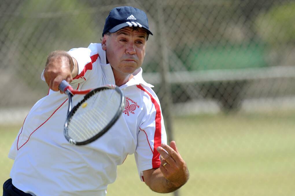 Peter Rogers slams down a serve for Telangatuk East. Rogers has been playing Wimmera tennis for a long time, and said he has enjoyed his team's step-up into the pennant division this season.