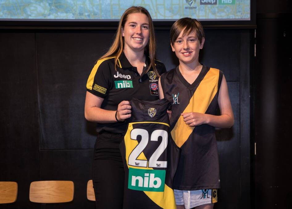 Nekaela Butler presents a guernsey to a youngster at the Richmond Tigers' season launch. Picture: RICHMOND TIGERS
