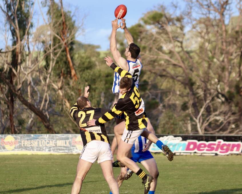 Michael Close flies high for a contested grab against Pimpinio at the weekend. Picture: BLAIR BURNS