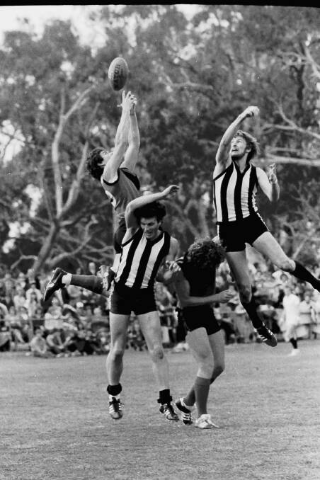 Players fly during the 1980 grand final.