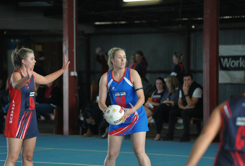 Rupanyup's Kayla Woods with the ball in hand inside Rupanyup's indoor netball court.