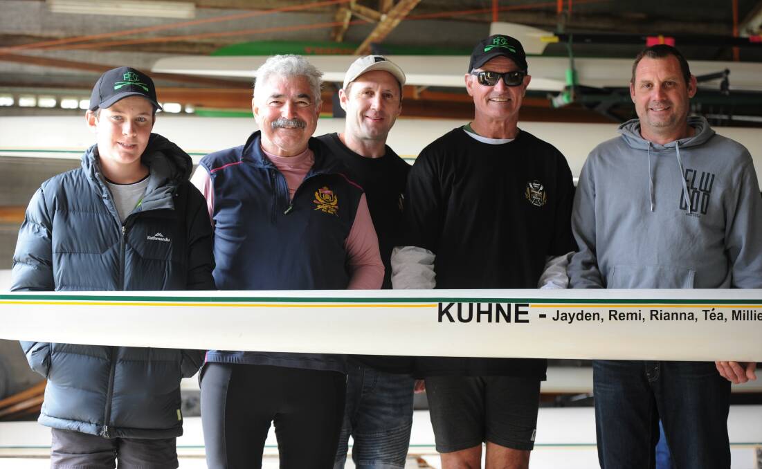 Ben Salter, Rod Pilmore, Robin Kuhne, John Nichols and Lyndon Kuhne with a boat donated by Ivan Kuhne. Picture: RICHARD CRABTREE