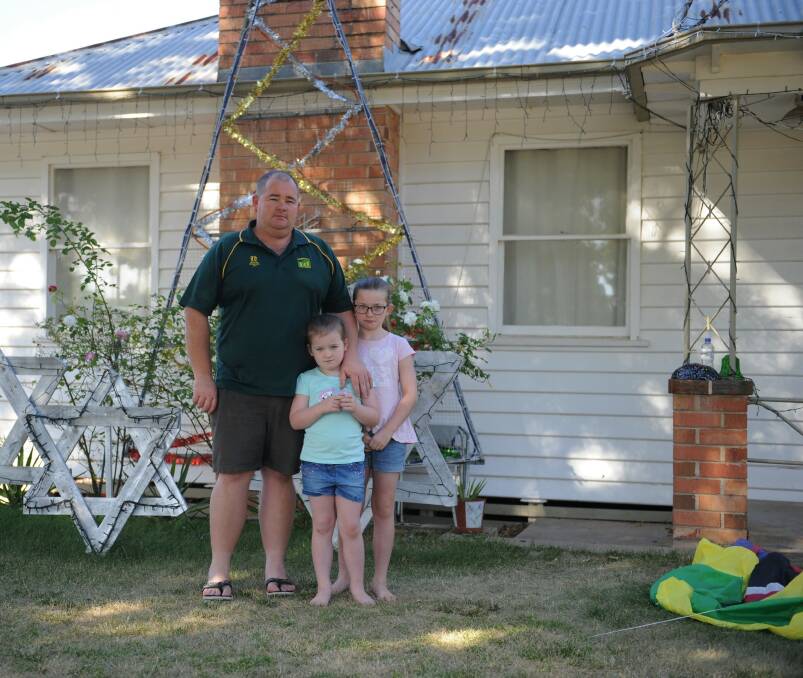 DEVASTATED: Michael Henderson with his daughters Sierra and Ava in front of their Dimboola house. Picture: SEAN WALES 
