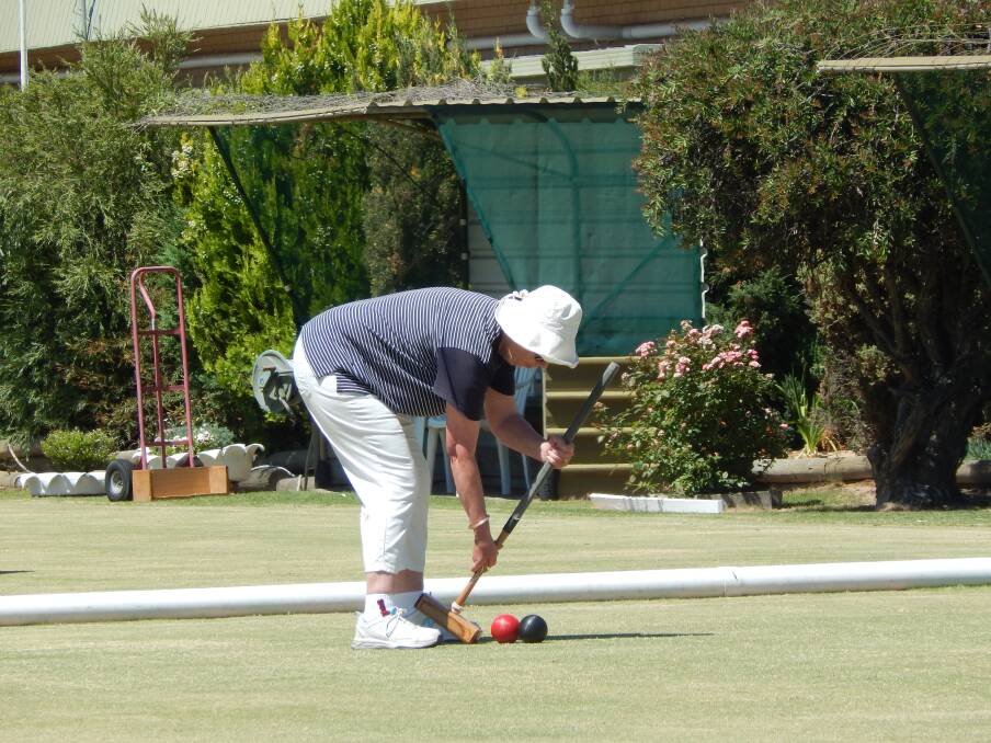 PRECISION: Kaye Blake enjoys a game of croquet at Kalimna Park Croquet Club's Christmas event in December. Picture: CONTRIBUTED