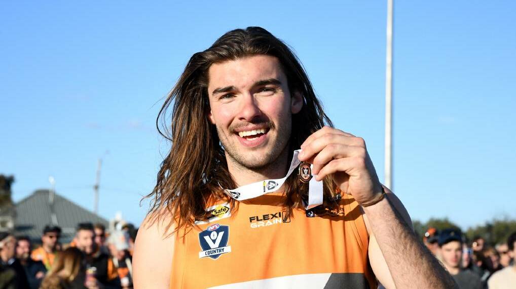 WINNER: Sam Weddell following the Giants' premiership win last season. He has just won a best and fairest in the Northern Territory with Waratah. 