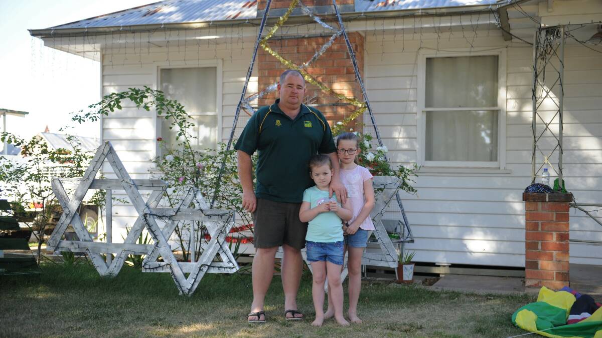 DEVASTATED: Michael Henderson with daughters Sierra and Ava in front of their Dimboola home where they had Christmas lights stolen. Picture: SEAN WALES