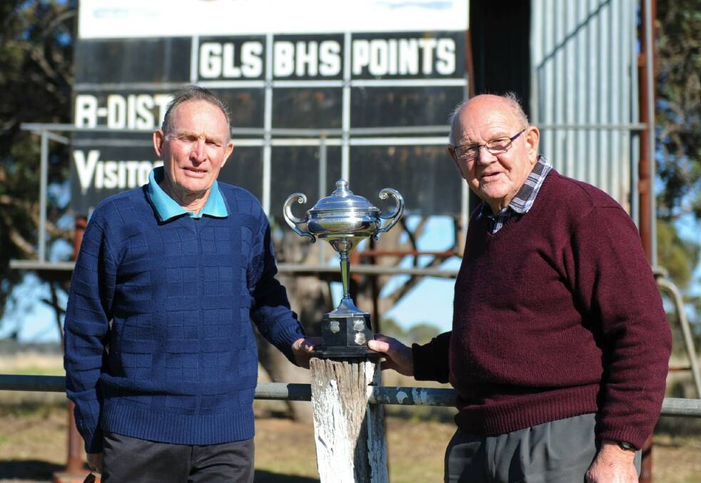REMINISCING: Fred Lowe and Rob Stacey with the Metters Cup. The Goroke Football Team claimed the cup with its fifth premiership of the 1950s in 1958. Picture: SEAN WALES