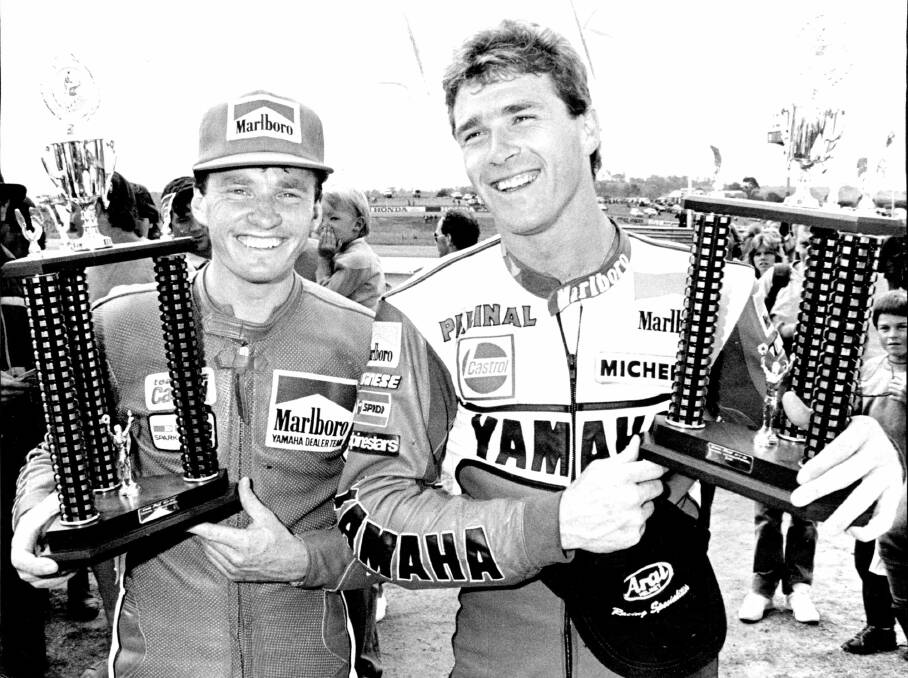 Kevin Magee (left), winner of the Oran Park round of the 1986 Swann Insurance Series, compares trophies with Surfers Paradise round winner and series leader Rob McElnea.