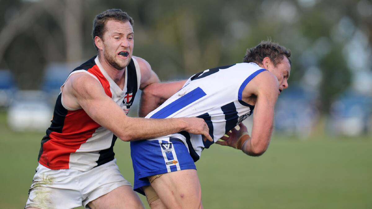 FIRST LOSS: Jeremy Kealy tackles Harrow-Balmoral's Michael Phelan last season. Kealy kicked two goals for the Saints in their loss to Rupanyup.