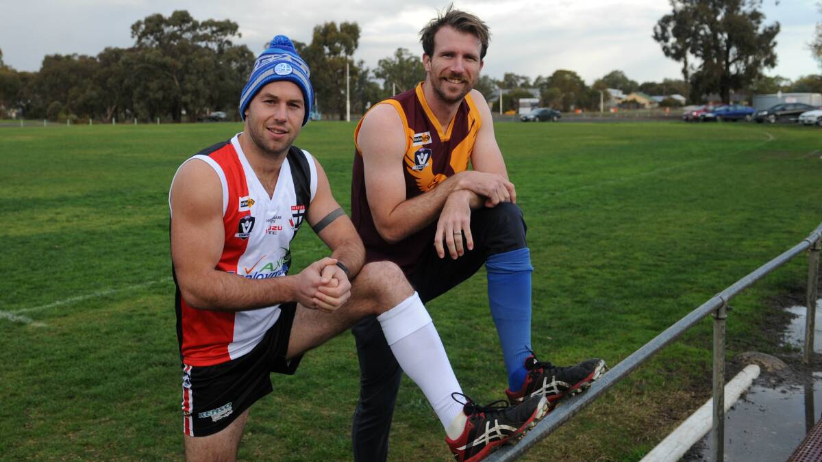 SOCK-IT: Horsham Saints coach Luke Fisher and Warrack Eagles assistant coach Shannon Argall model the socks their teams will wear in Saturday's clash. Picture: STUART McGUCKIN