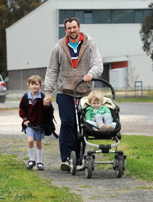 Ben Peucker and his children Lilly and Dusty, Holy Trinity Lutheran School students Walk To School month in 2016. Peucker representing the Laharum colours.