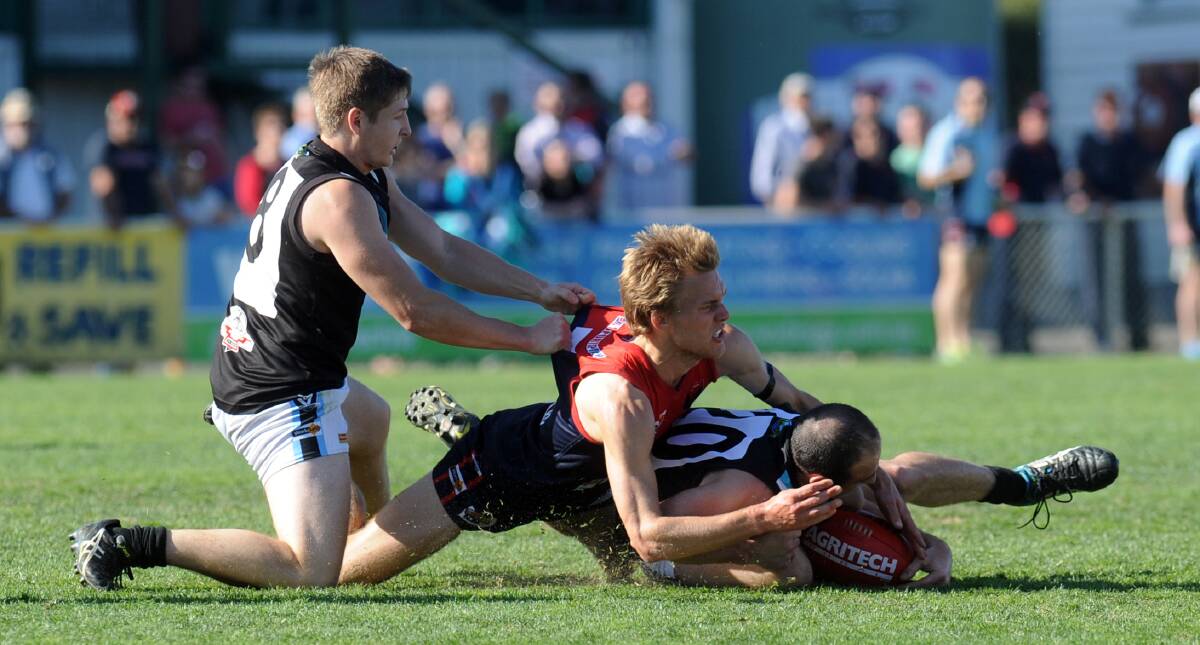 SIGNED ON: Daniel Easson lays a tackle for Laharum during the 2014 Horsham District grand final against the Swifts. Easson has re-joined the Demons, but will be unavailable for selection this week. 