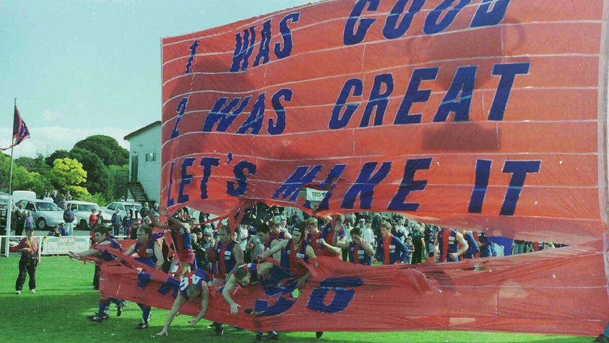Rupanyup players fall through the banner running onto City Oval for the 1998 grand final.
