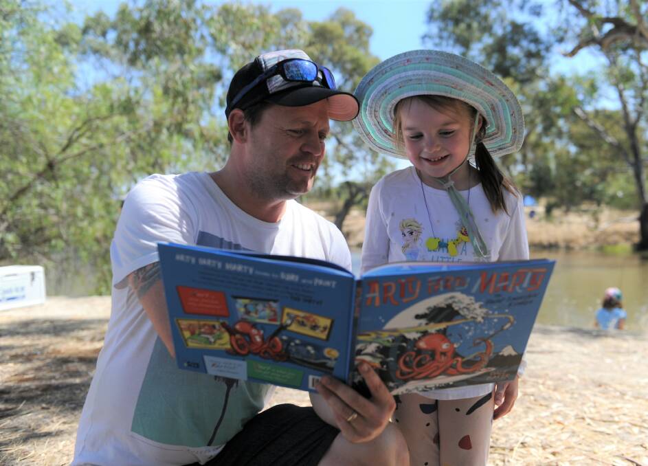 BIG STEP: Dale Baker with his book and an avid reader alongside the Wimmera River. The book has been nominated for an award under the Picture Story Book category. Picture: DAINA OLIVER