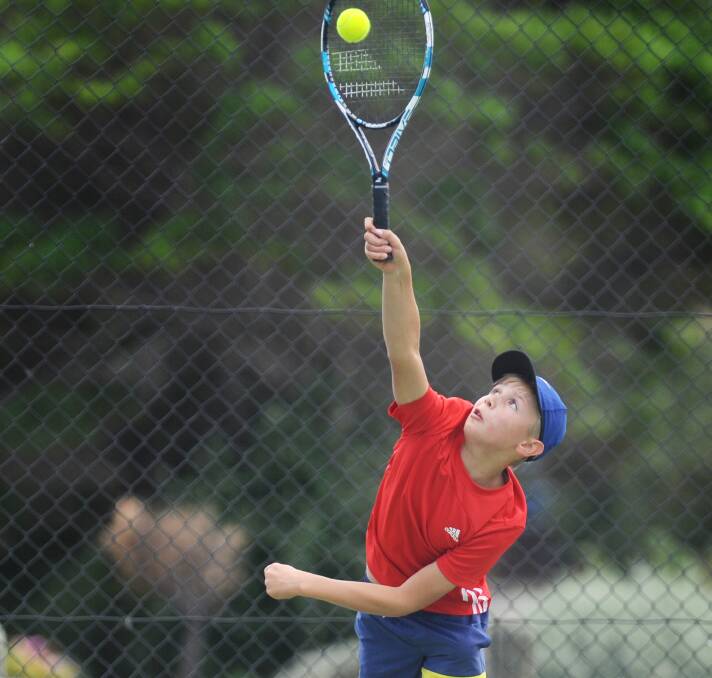 Tom Hindhaugh serves in a junior competition last season. 