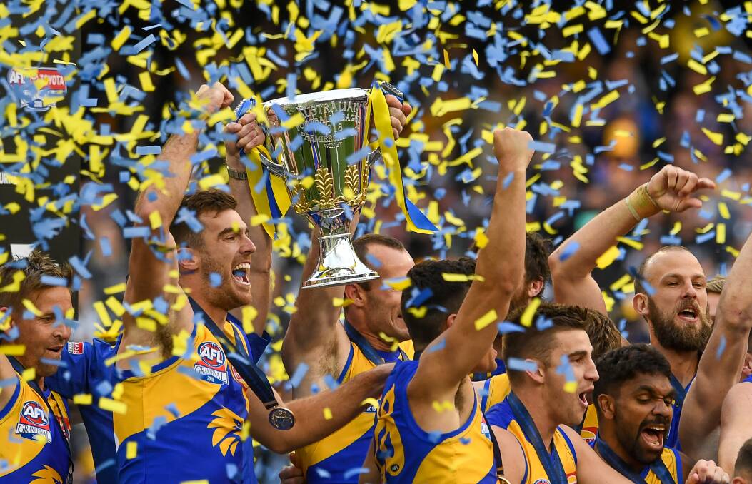CELEBRATION: West Coast Eagles players celebrate with the 2018 premiership cup after defeating Collingwood on Saturday. Picture: Justin McManus