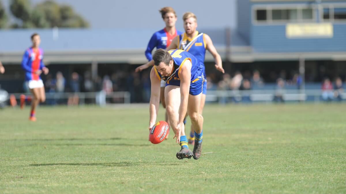 PICK UP: Craig Britten gathers the ball for Natimuk United against Rupanyup last week. Picture: SEAN WALES