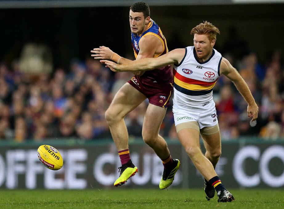 Daniel McStay of the Lions competes with Kyle Cheney of the Crows during round 18 at the Gabba in Brisbane, Saturday, July 21, 2018. Picture: AAP Image/Jono Searle