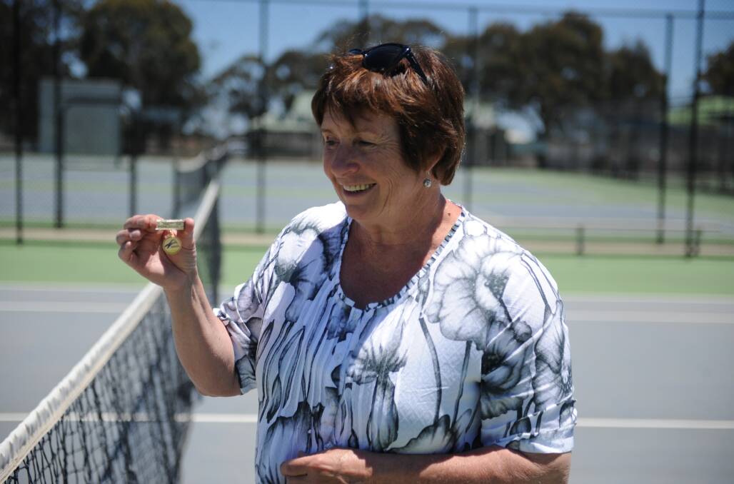 Sue Exell with her pin from Tennis Victoria.  Picture: SEAN WALES